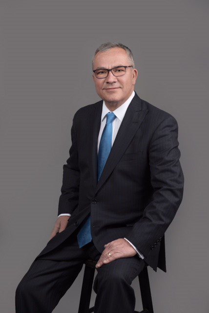 Professional photo of Michel Stanciu wearing a business attire while sitting